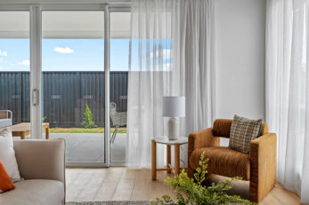 view of lounge chair in corner of lounge room with outside visible through sliding doors