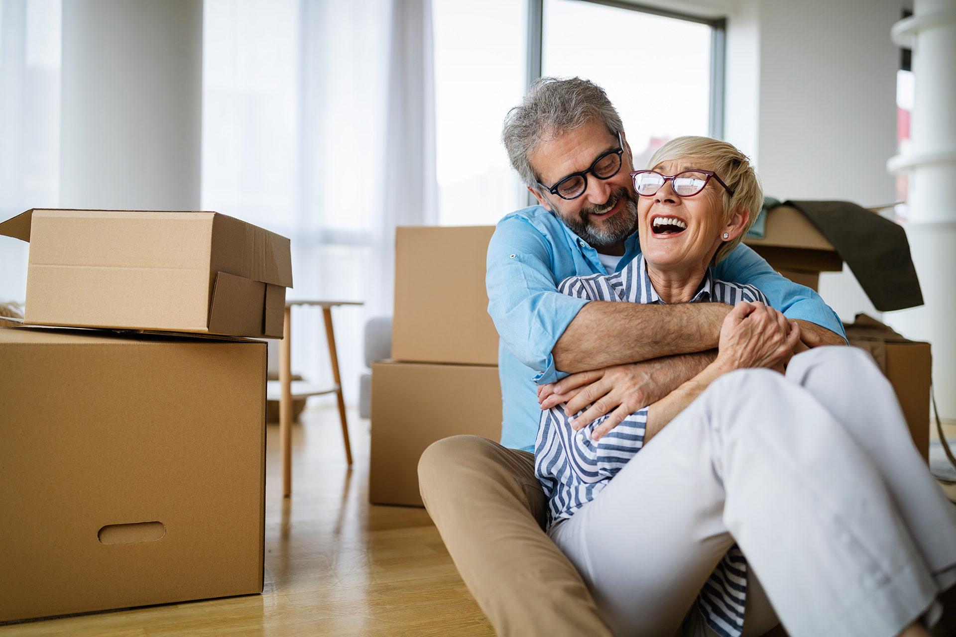 Happy retired couple moving into home